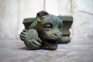 A Rare Medieval Period Carved Stone Grotesque Holding a Coconut c.1300-1400