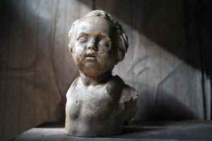 An Early 20thC Plaster Portrait Bust of a Young Boy